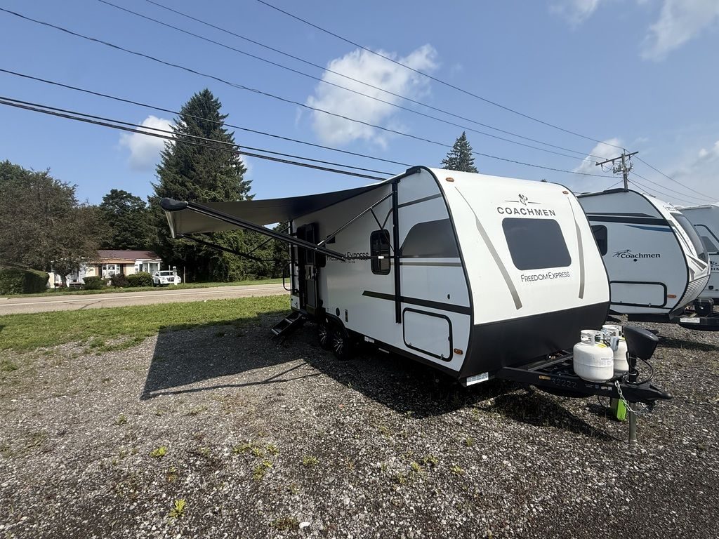 A Coachmen Freedom Express travel trailer with its awning out