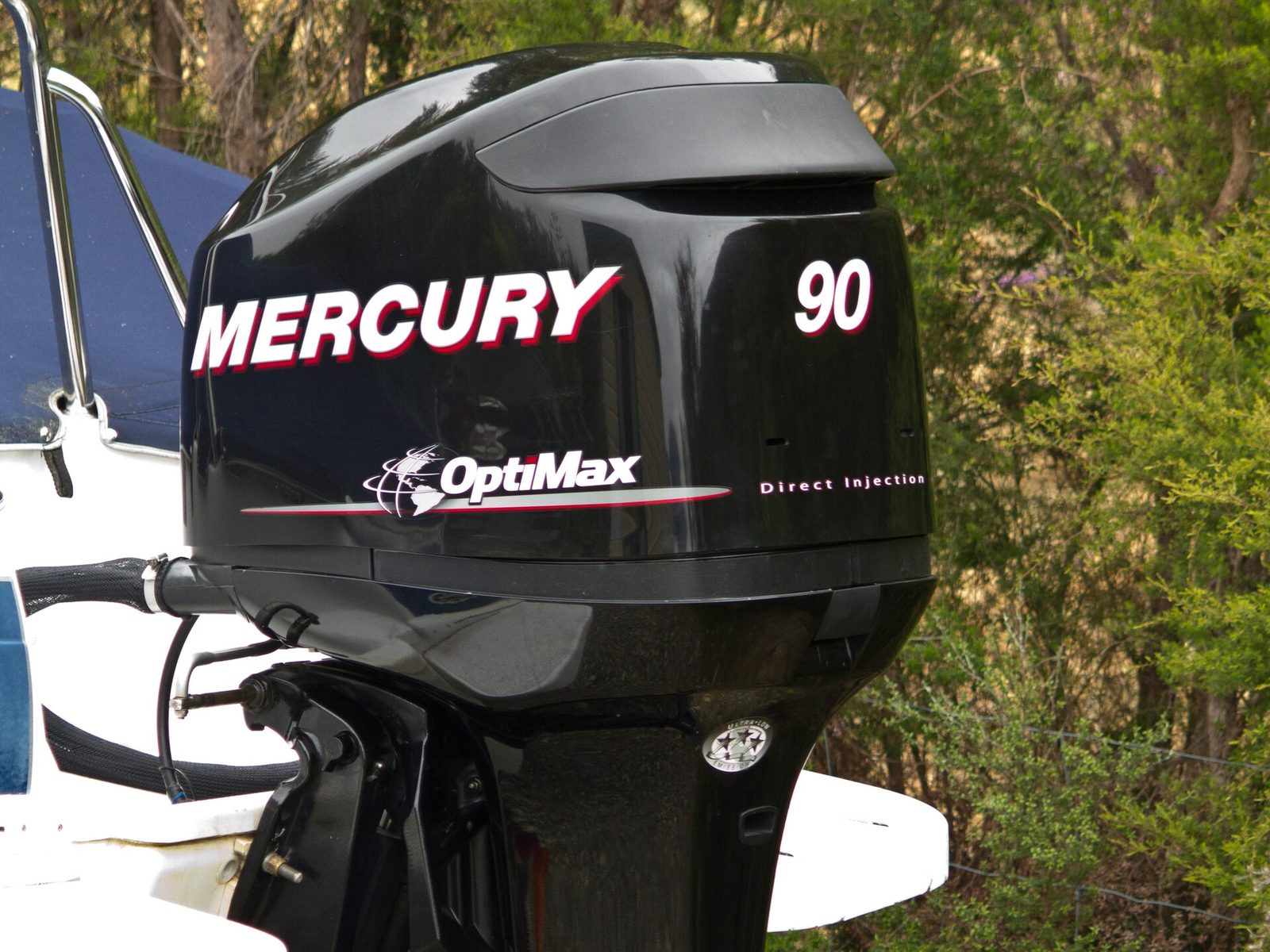 A Mercury OptiMax 90 outboard on a boat transom