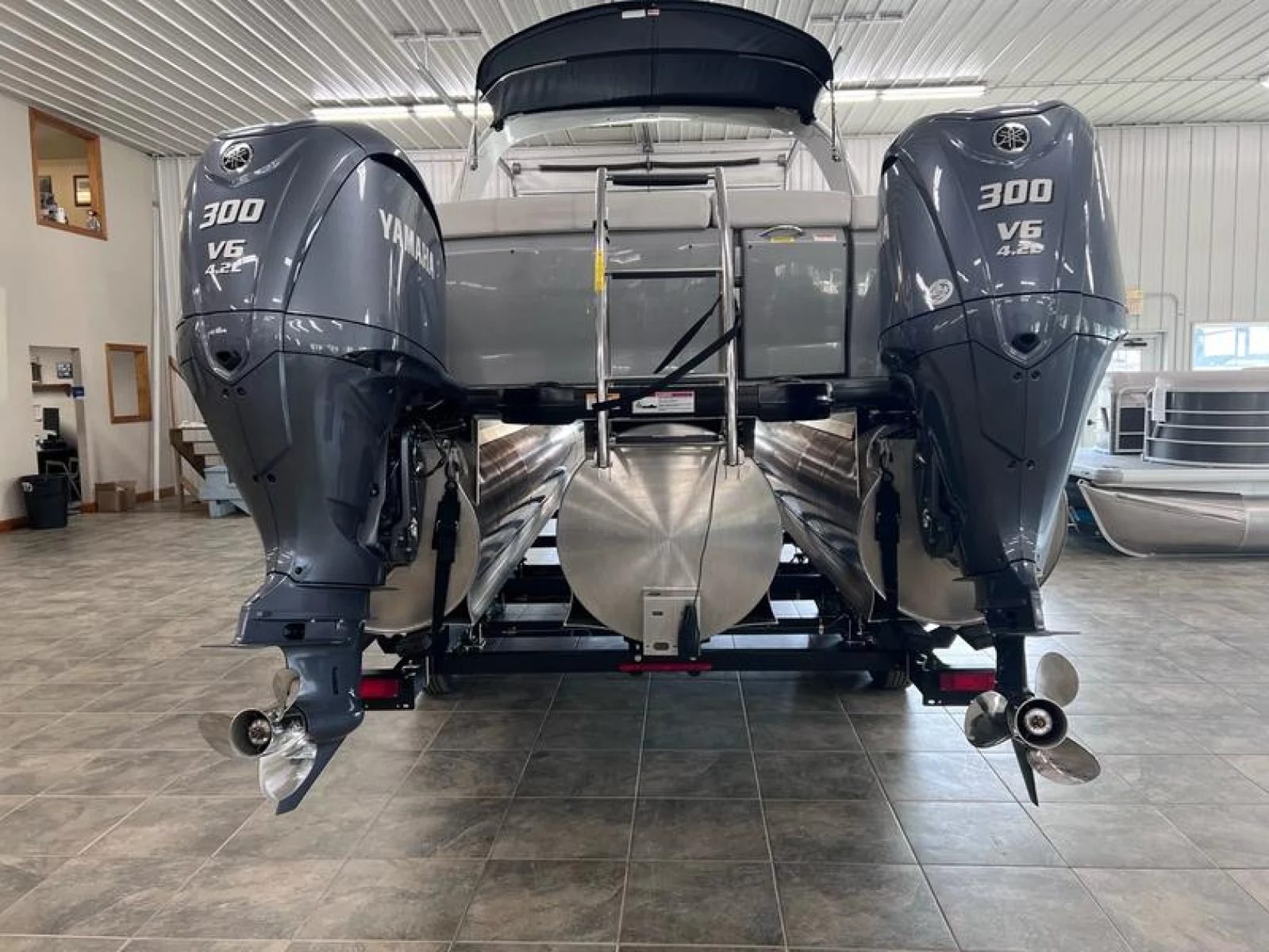 Twin Yamaha 300 V8 outboards on a tritoon in the Lime Lake showroom